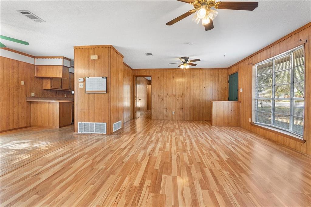 519 Tolson Avenue Van Alstyne, TX 75495 - Photo 10 of 25 a spacious bedroom with a bed and a chandelier