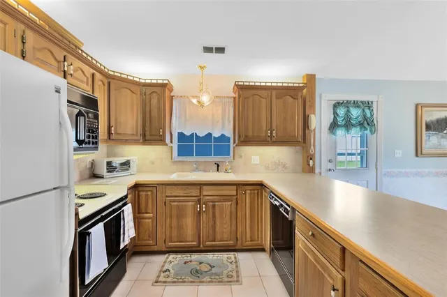 a kitchen with a sink and a stove