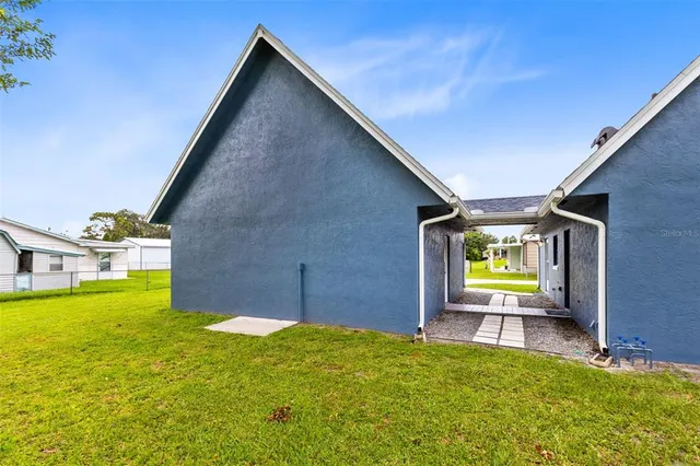 an aerial view of a residential houses with outdoor space and swimming pool