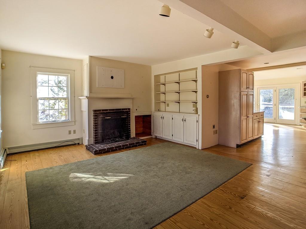678 Point Road Marion, MA 02738 - Photo 13 of 33 an empty room with windows and fireplace