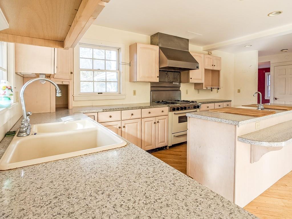 678 Point Road Marion, MA 02738 - Photo 18 of 33 a kitchen with stainless steel appliances granite countertop a sink stove and cabinets