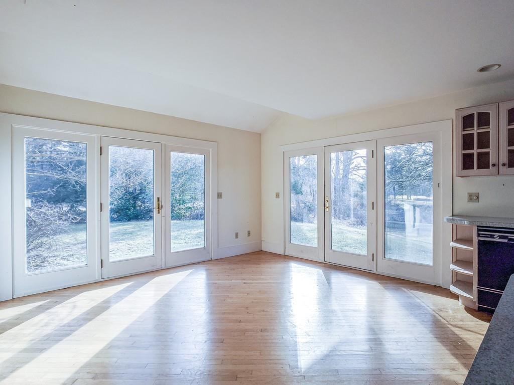678 Point Road Marion, MA 02738 - Photo 6 of 33 a view of an empty room with wooden floor and a window