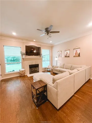 a living room with furniture fireplace and flat screen tv