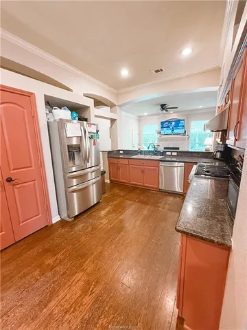 a kitchen with granite countertop stainless steel appliances and wooden cabinets