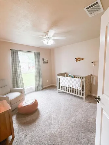 a spacious bedroom with a bed and a couch