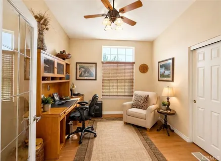 a view of a livingroom with workspace and a window