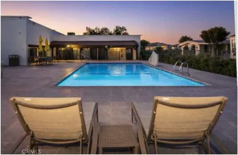 a view of a backyard with a patio and a garden