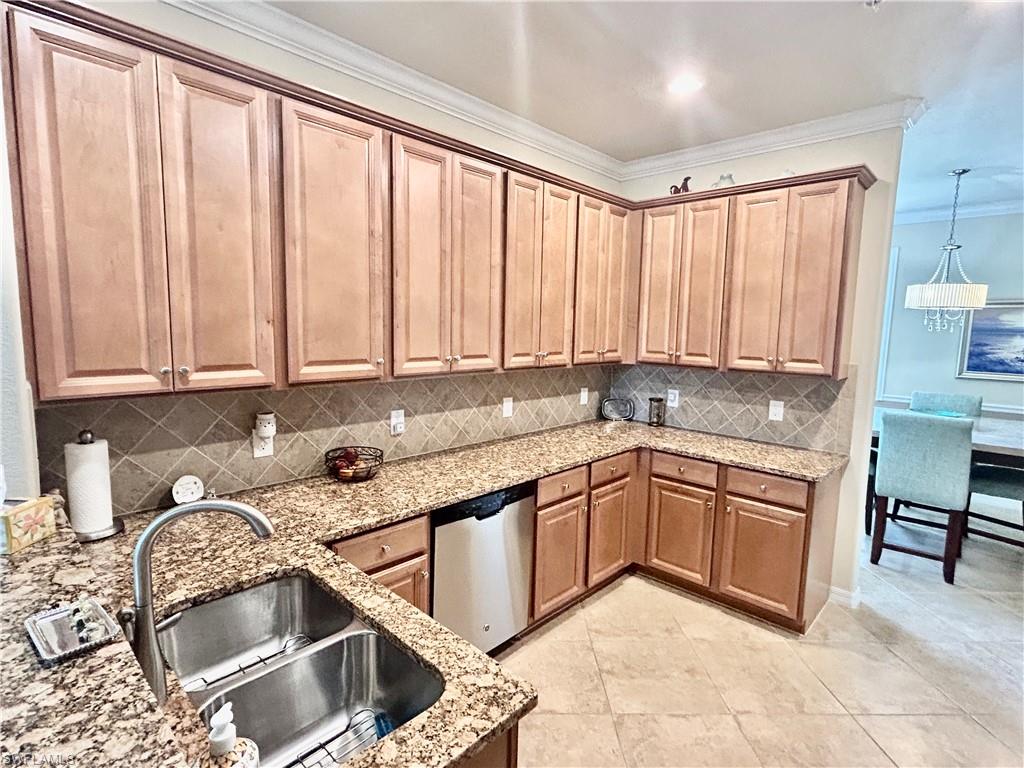9511 Napoli Lane, Unit 202 Naples, FL 34113 - Photo 16 of 50 a kitchen with granite countertop a sink and a stove top oven