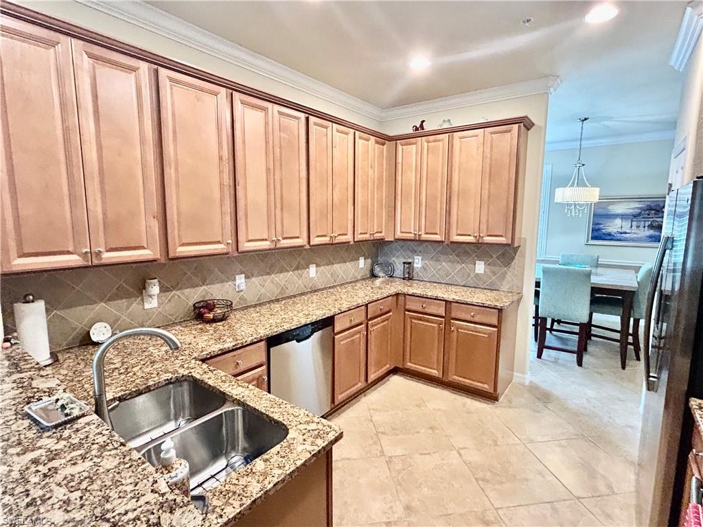 9511 Napoli Lane, Unit 202 Naples, FL 34113 - Photo 18 of 50 a kitchen that has a sink and a stove in it
