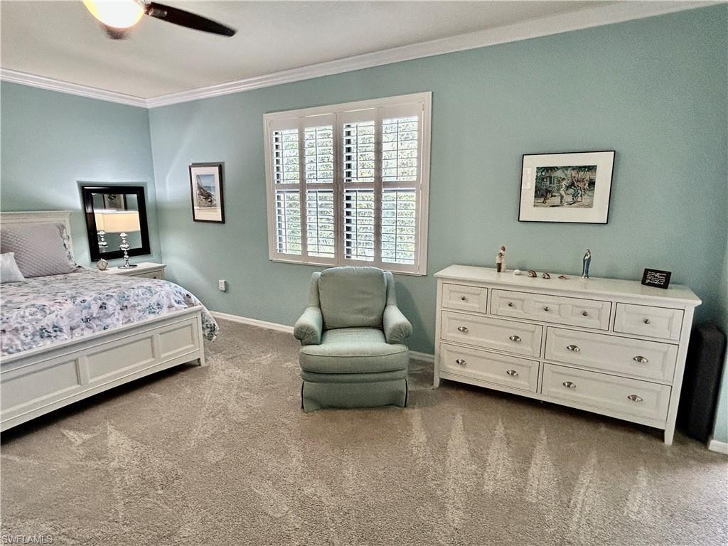 9511 Napoli Lane, Unit 202 Naples, FL 34113 - Photo 25 of 50 a bedroom with a bed and a dresser