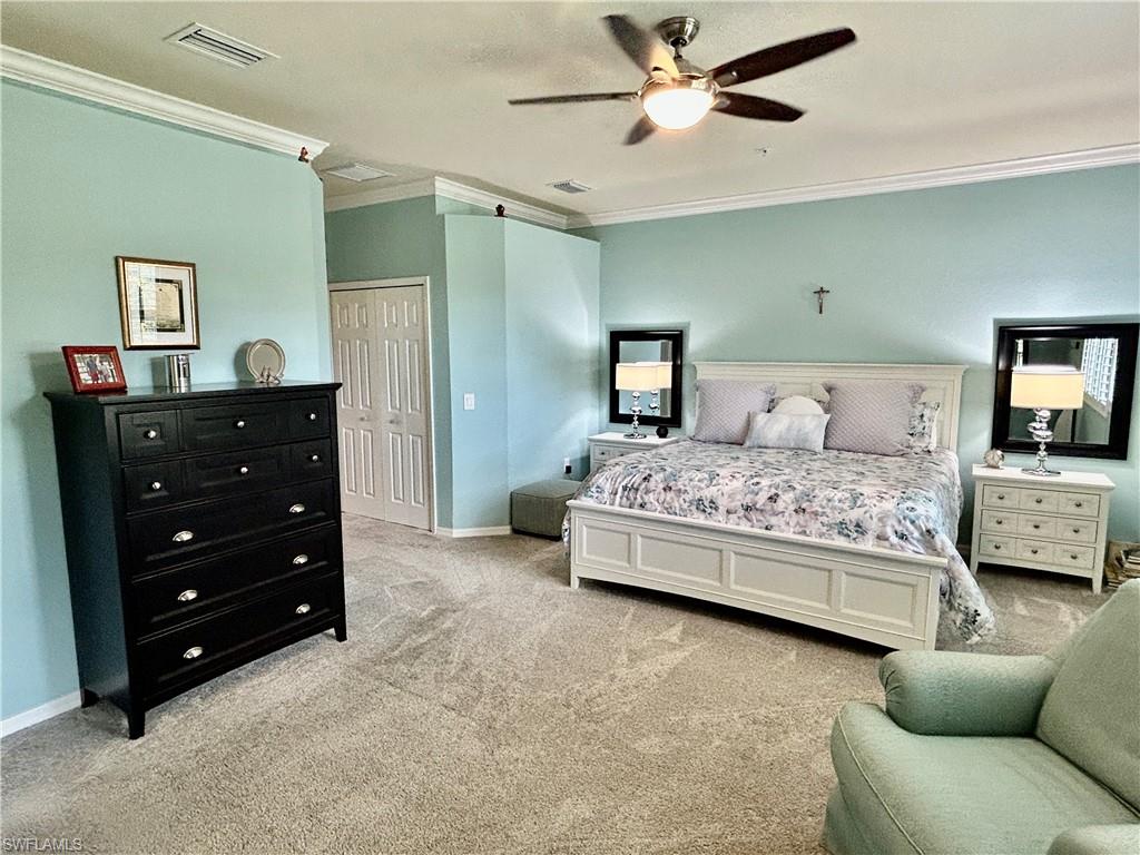 9511 Napoli Lane, Unit 202 Naples, FL 34113 - Photo 26 of 50 a bedroom with a bed and a dresser