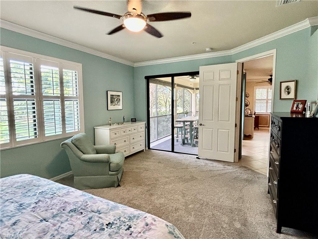 9511 Napoli Lane, Unit 202 Naples, FL 34113 - Photo 27 of 50 a living room with furniture and large windows