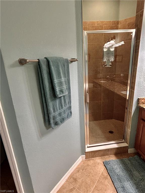 9511 Napoli Lane, Unit 202 Naples, FL 34113 - Photo 30 of 50 a bathroom with a glass shower door and a mirror