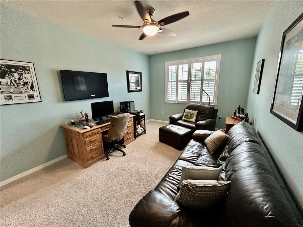 9511 Napoli Lane, Unit 202 Naples, FL 34113 - Photo 32 of 50 a living room with furniture ceiling fan and a window