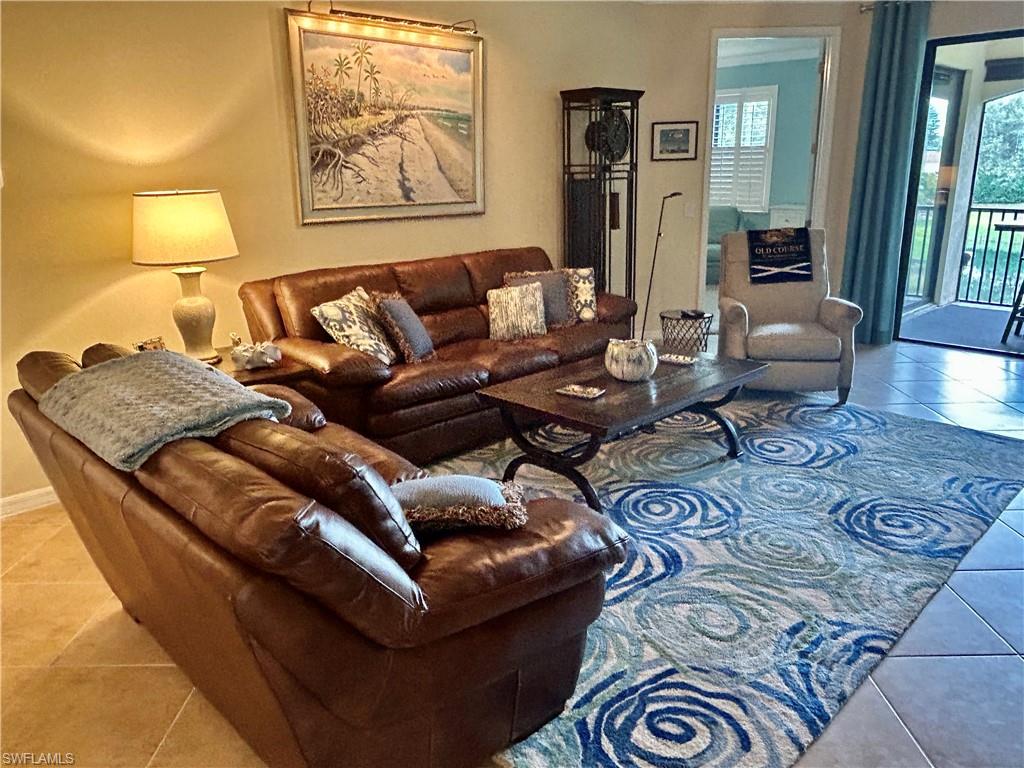 9511 Napoli Lane, Unit 202 Naples, FL 34113 - Photo 8 of 50 a living room with furniture and wooden floor