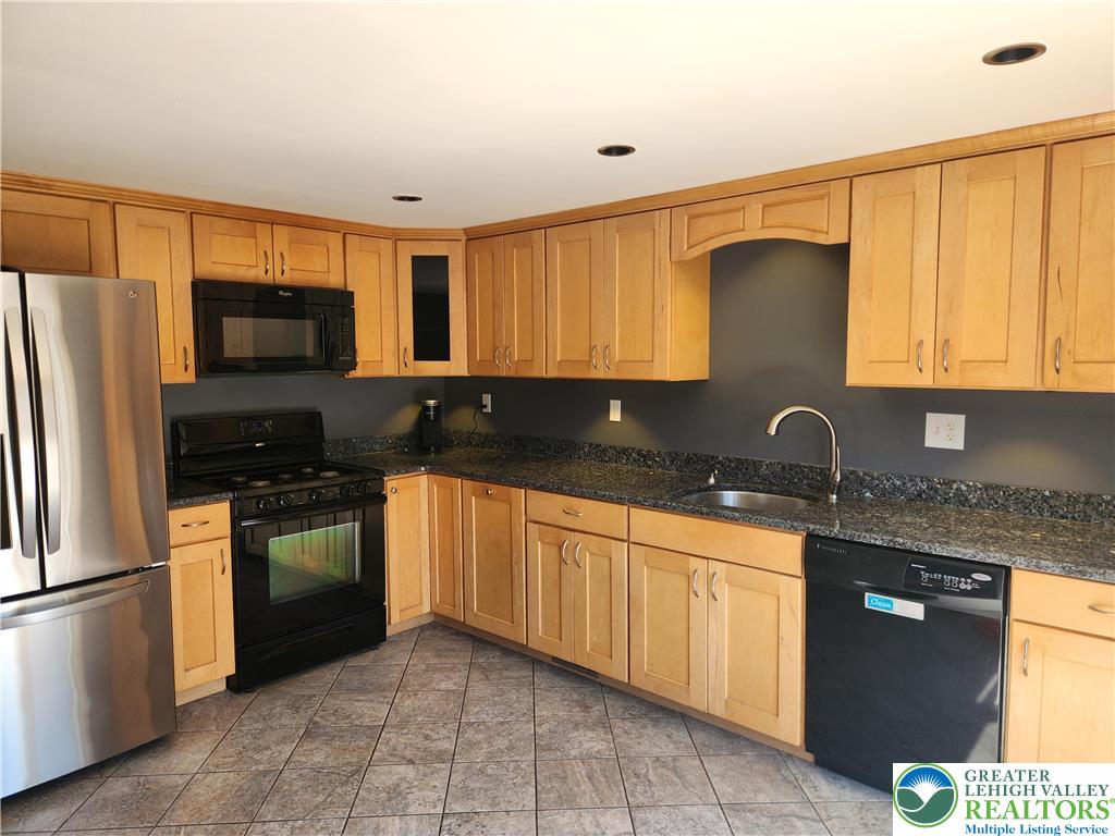 18 George Avenue Nazareth, PA 18064 - Photo 4 of 15 a kitchen with granite countertop a sink stainless steel appliances and cabinets