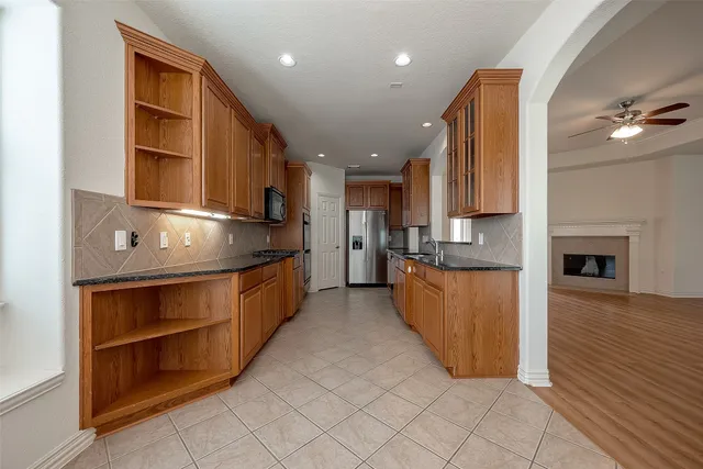 a kitchen with stainless steel appliances granite countertop a stove a sink and a refrigerator