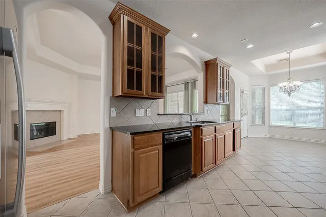 a large kitchen with stainless steel appliances granite countertop a stove and a sink