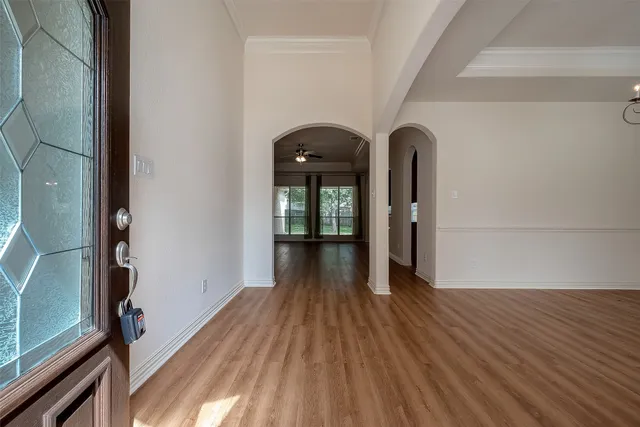 a view of a hallway with wooden floor