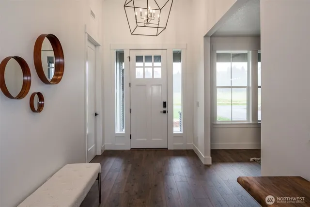 a view of a room with wooden floor and windows