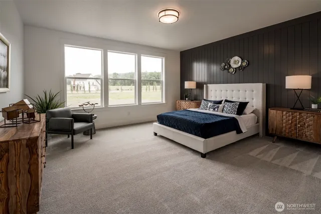 a spacious bedroom with a bed couch and a large window