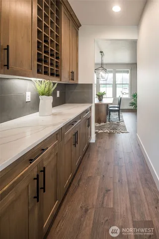 a kitchen with a sink and wooden floor