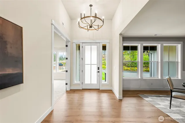 a view of a livingroom with wooden floor and a large window