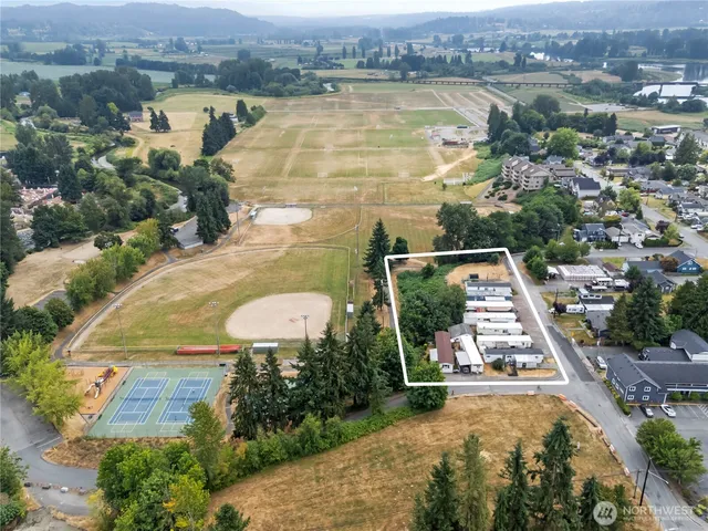 an aerial view of a house with a garden and lake view