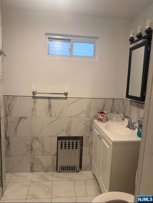 380 Semel Avenue Garfield, NJ 07026 - Photo 11 of 19 a bathroom with a sink and mirror