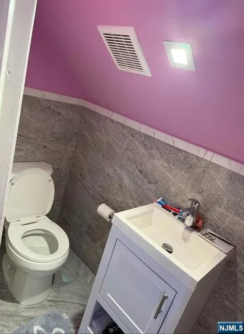 a white toilet sitting next to a bathroom sink