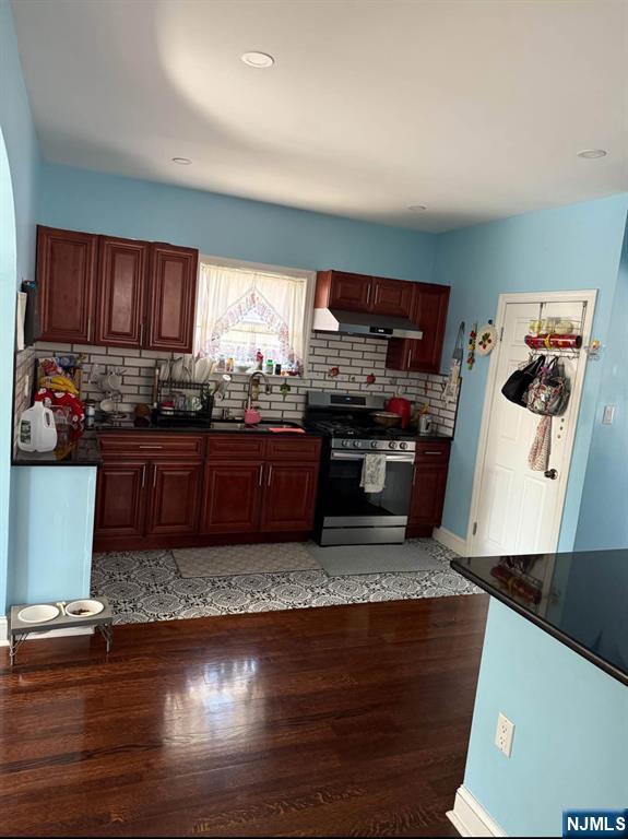 380 Semel Avenue Garfield, NJ 07026 - Photo 3 of 19 a kitchen with stainless steel appliances granite countertop a stove a sink and a refrigerator