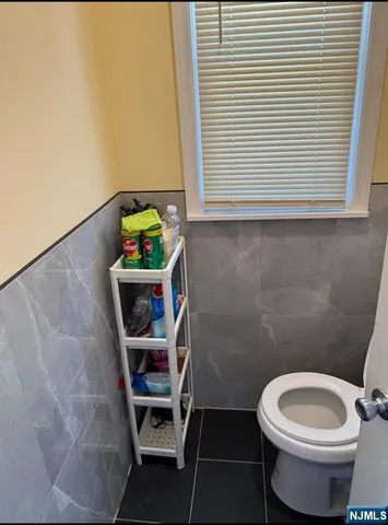 a bathroom with a toilet and a window