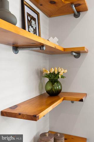 a vase of flowers sitting on a shelf