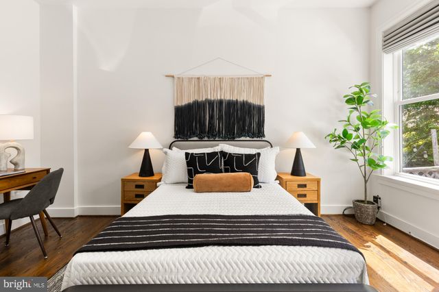 a bedroom with a bed and a potted plant