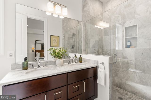a bathroom with a sink double vanity and a mirror