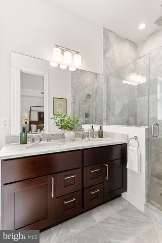 a bathroom with a sink double vanity and a mirror
