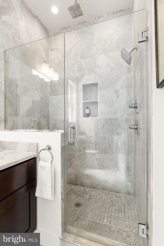 a bathroom with a shower and a sink