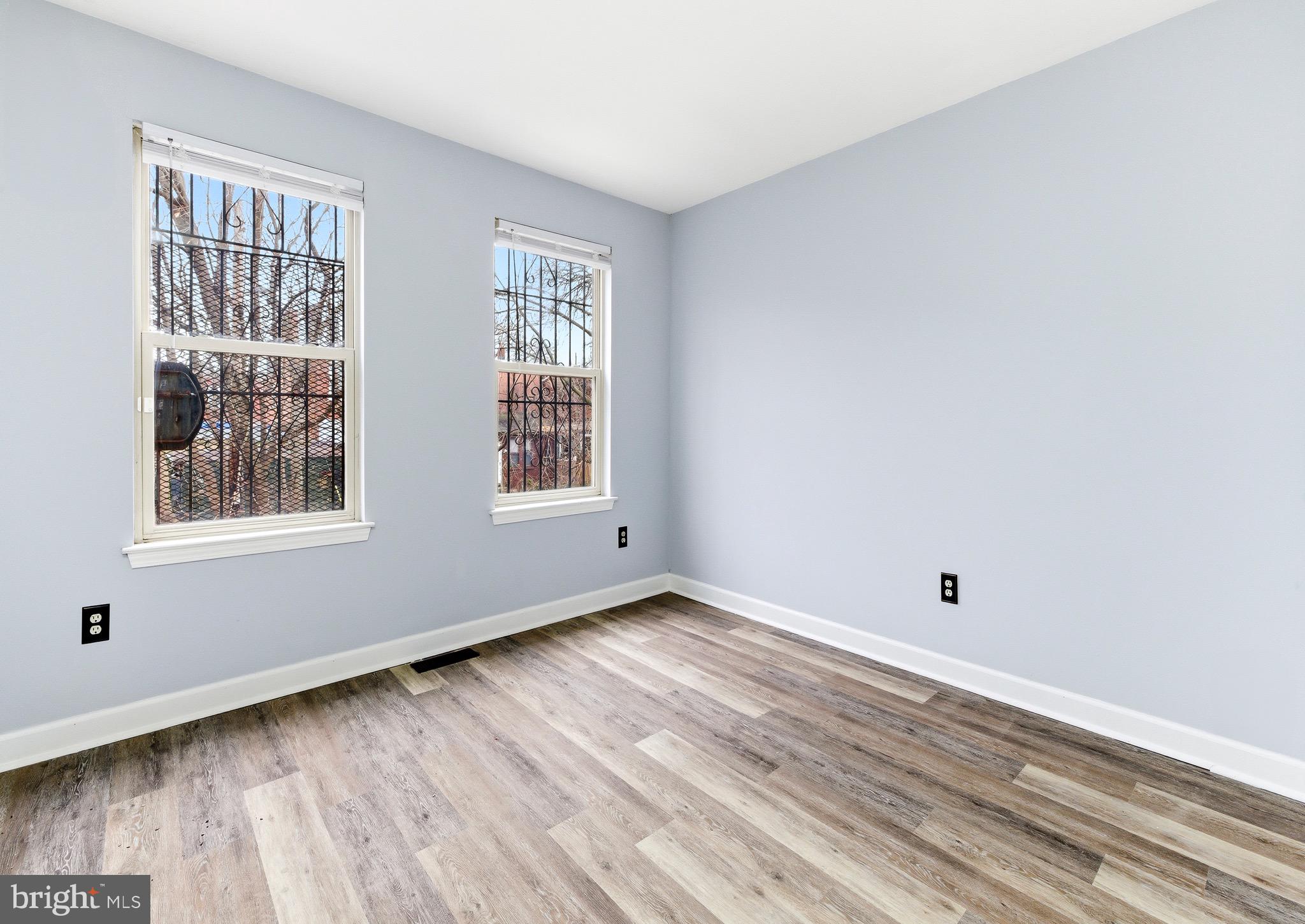 576 Washington Street Camden, NJ 08103 - Photo 15 of 25 a view of an empty room with wooden floor and a window
