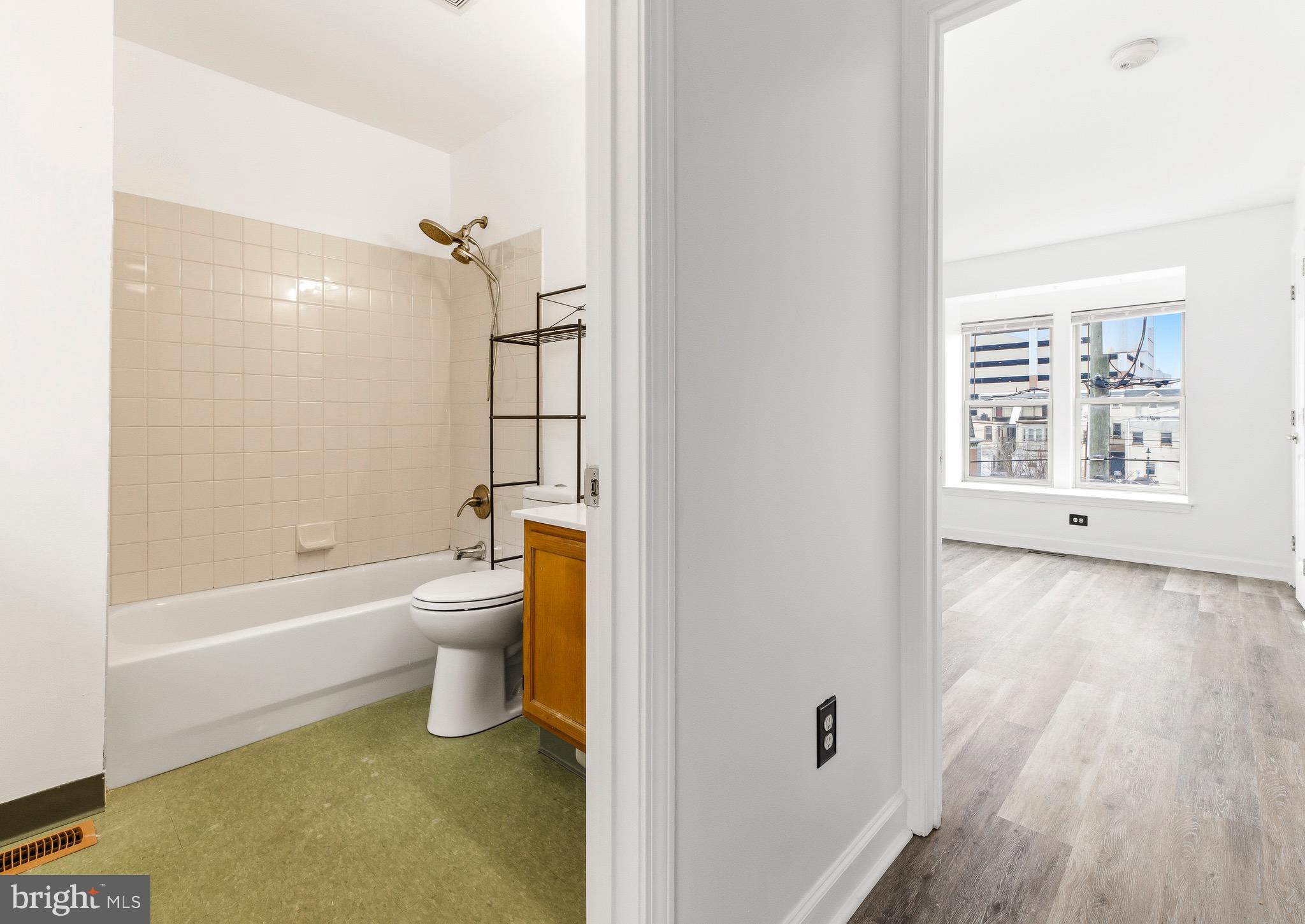 576 Washington Street Camden, NJ 08103 - Photo 17 of 25 a bathroom with a toilet a sink and bathtub