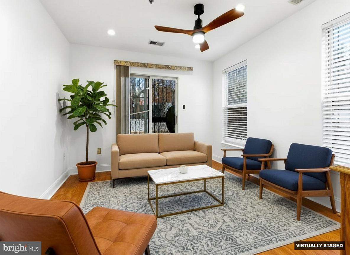 576 Washington Street Camden, NJ 08103 - Photo 5 of 25 a living room with furniture and a potted plant