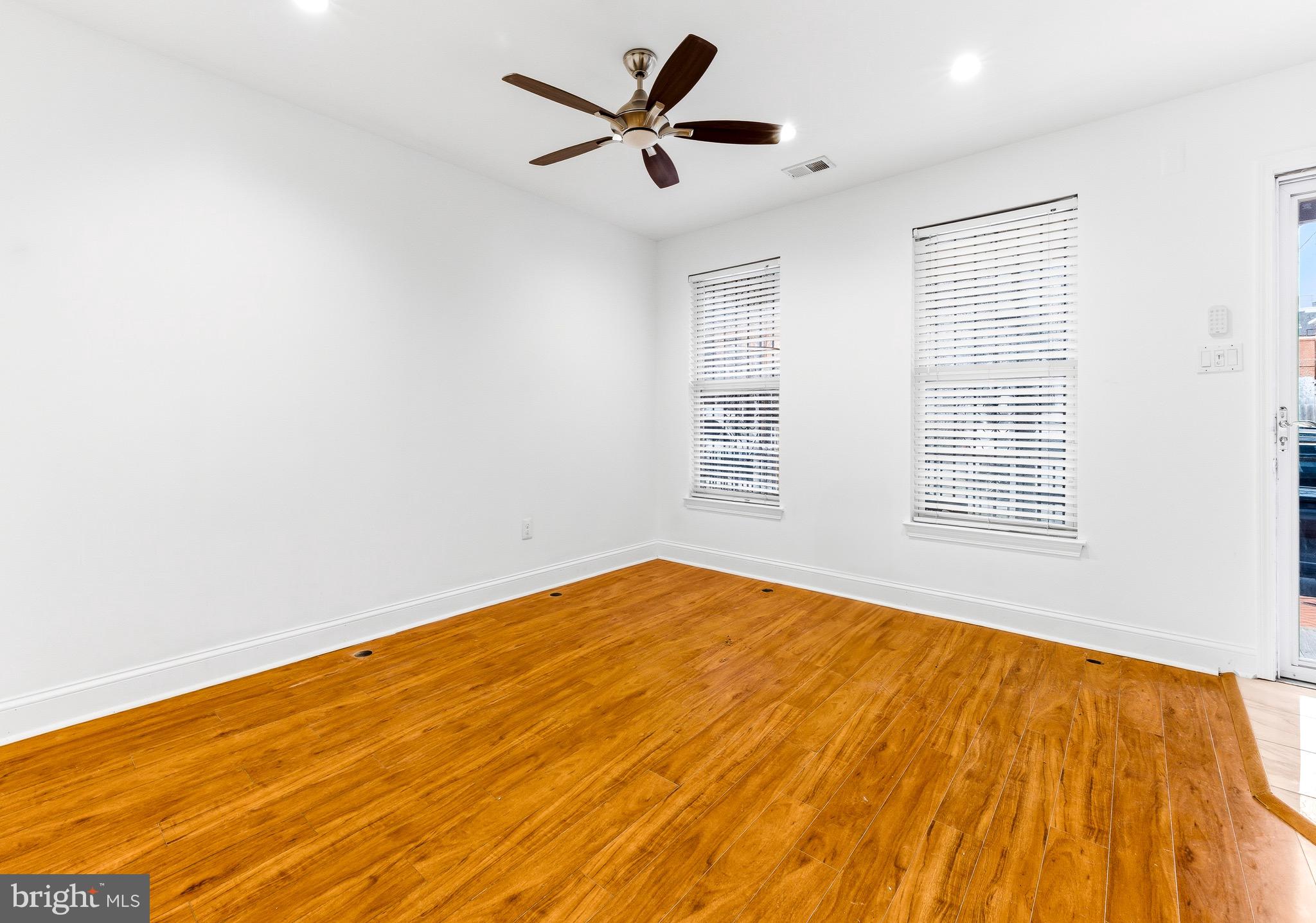 576 Washington Street Camden, NJ 08103 - Photo 10 of 25 a view of empty room with wooden floor and fan