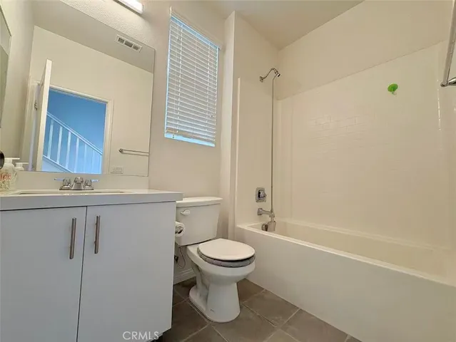a bathroom with a toilet sink and shower