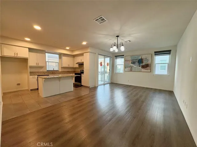 a view of a kitchen with a sink a refrigerator and window