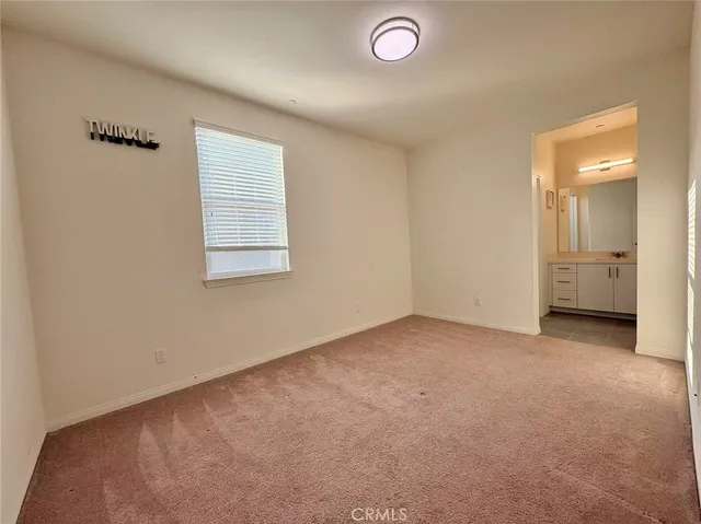an empty room with closet and a window