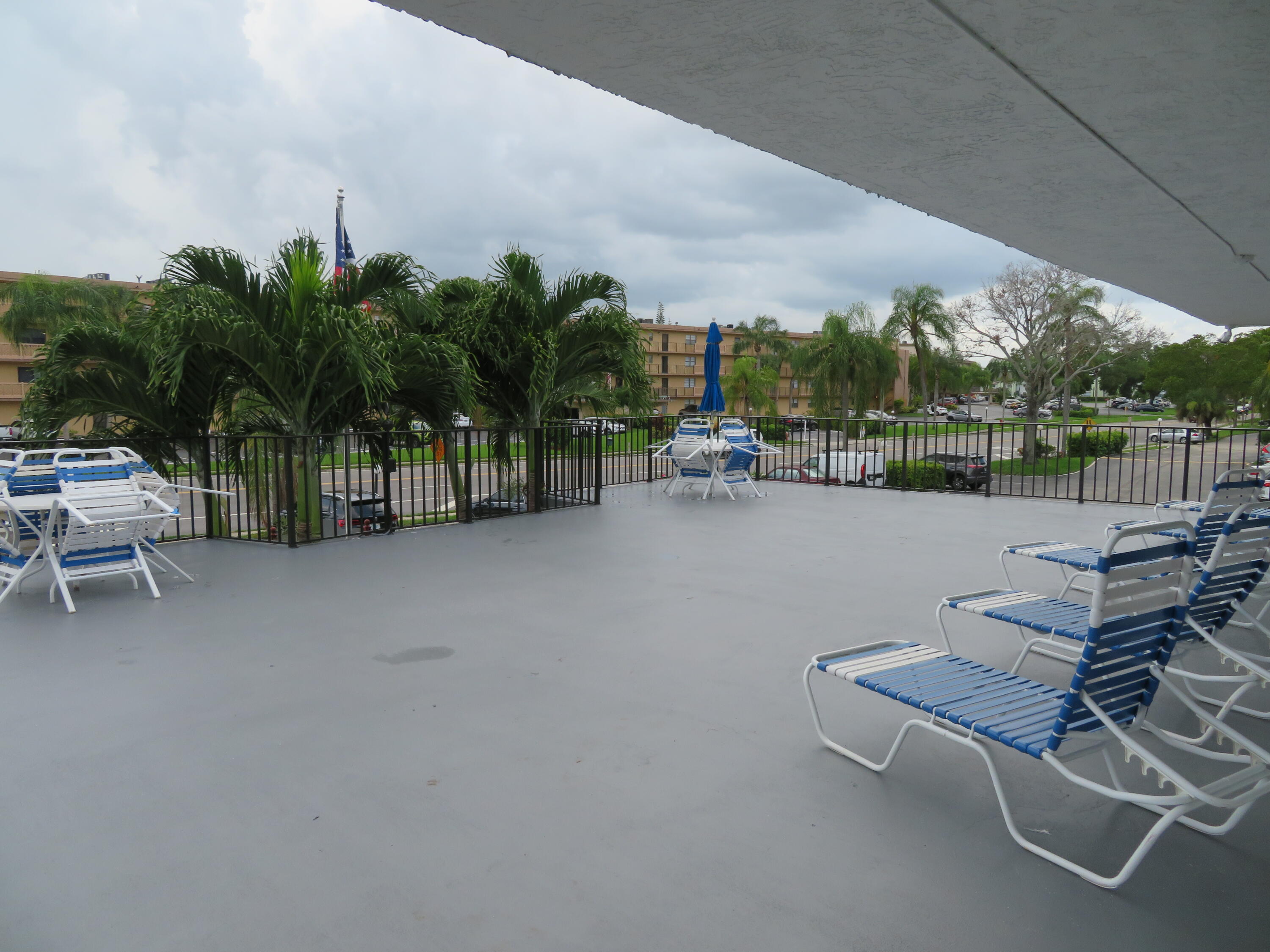 9233 Southwest 8th Street, Unit 117 Boca Raton, FL 33428 - Photo 16 of 37 a view of a terrace with sitting area