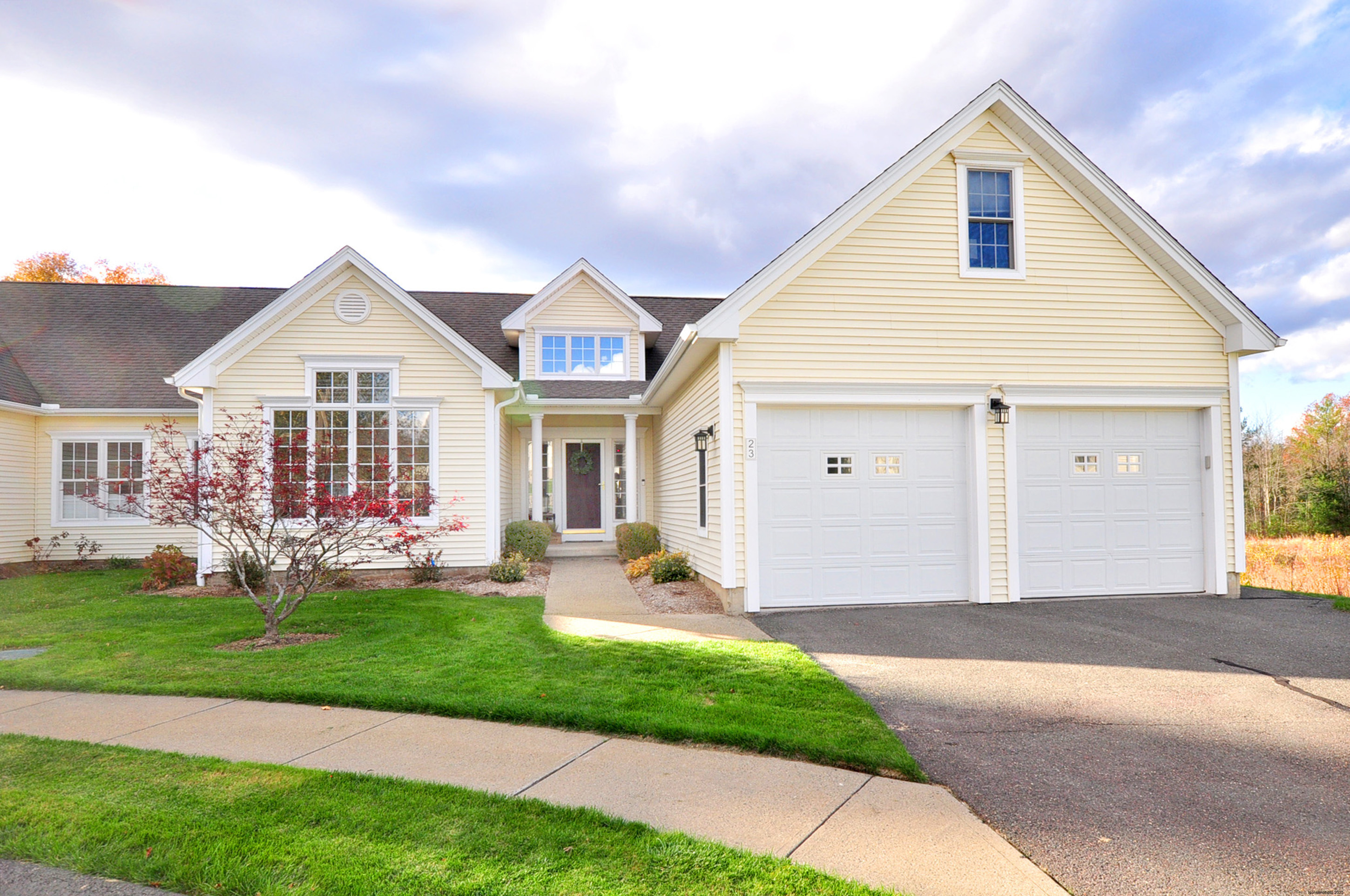 23 Dewberry Court, Unit 23 Suffield, CT 06078 - Photo 1 of 40 a front view of a house with a garden and yard