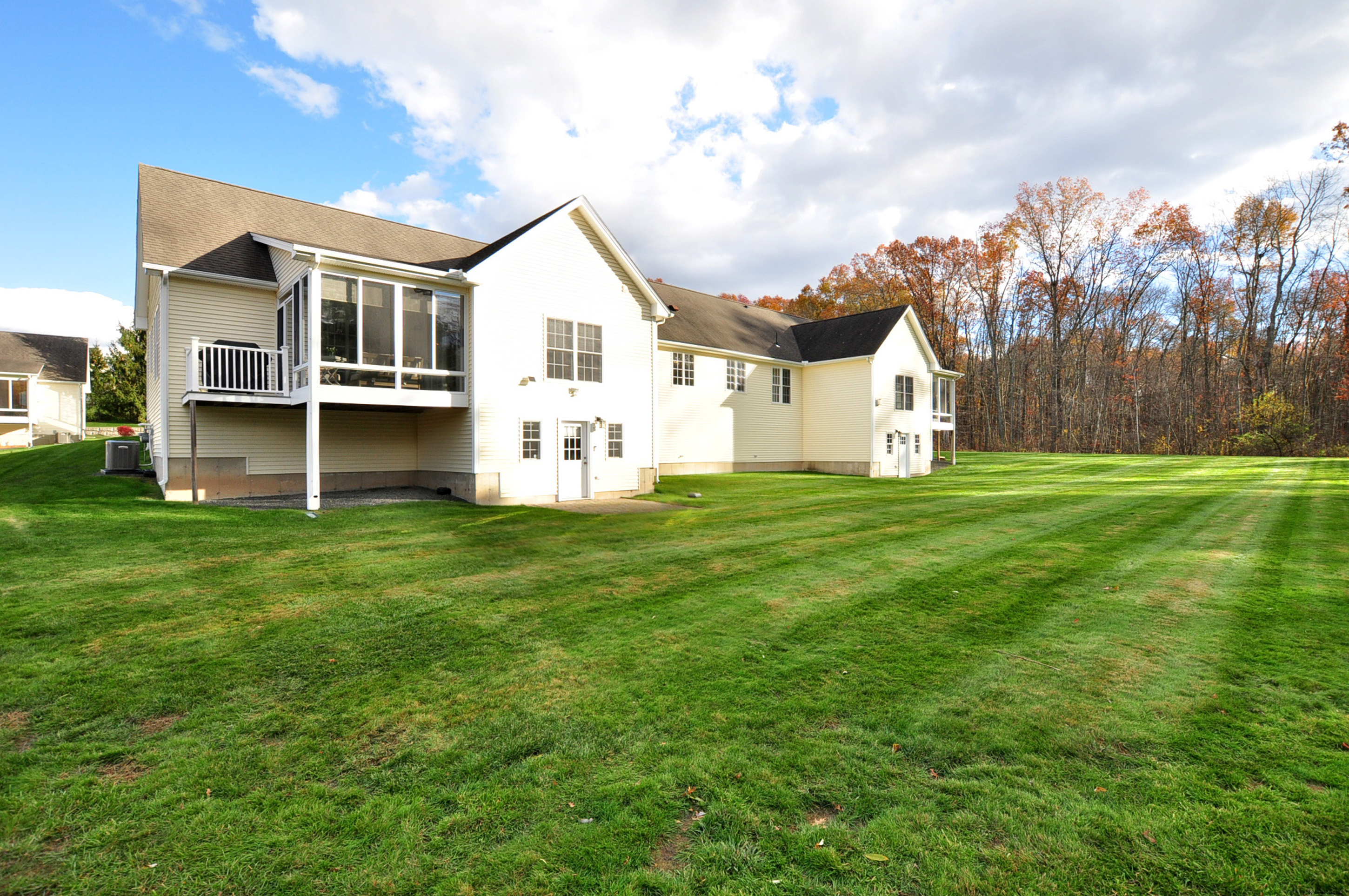 23 Dewberry Court, Unit 23 Suffield, CT 06078 - Photo 2 of 40 a view of a white house with a big yard and large trees