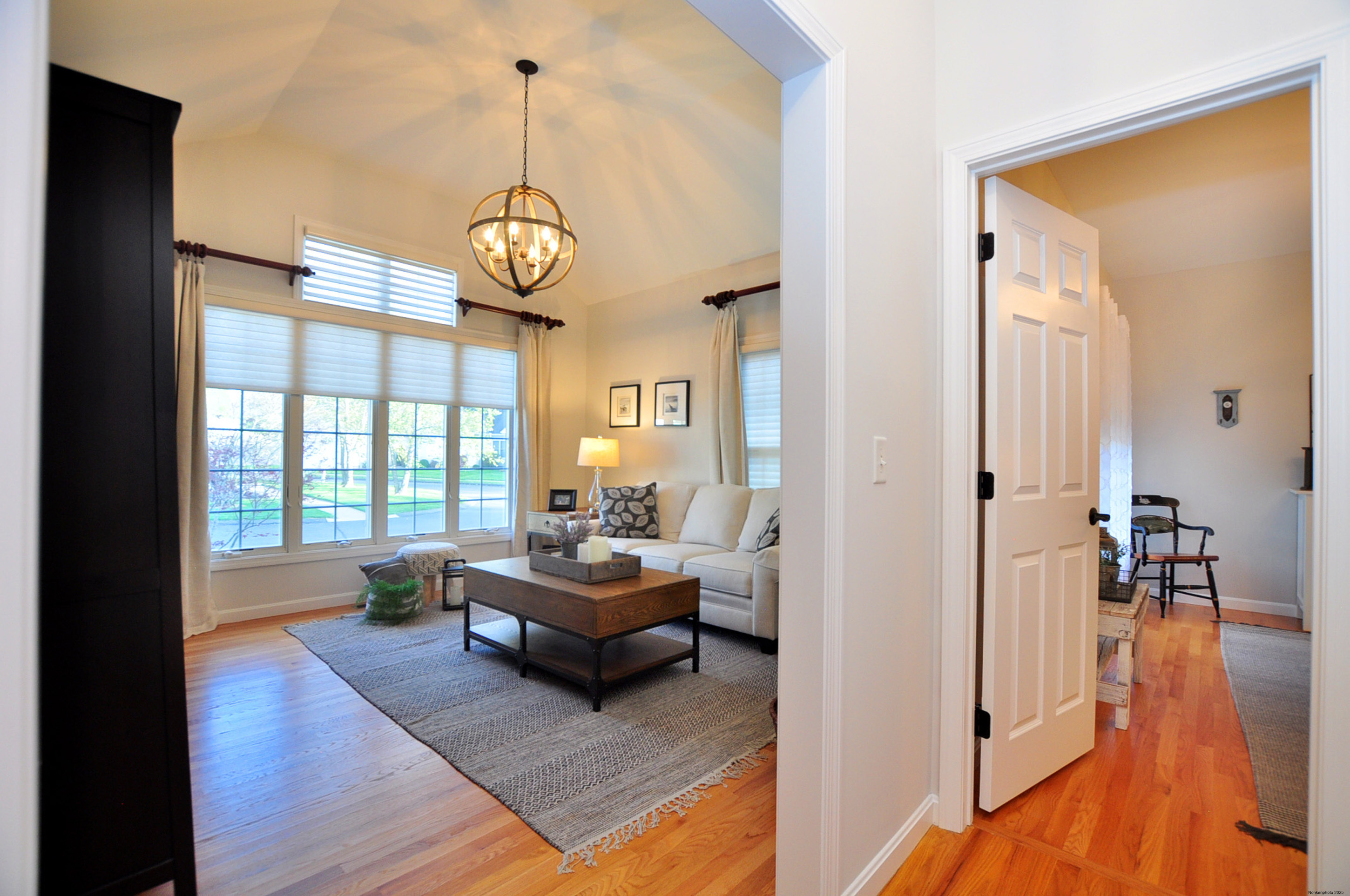 23 Dewberry Court, Unit 23 Suffield, CT 06078 - Photo 26 of 40 a living room with furniture wooden floor and a chandelier