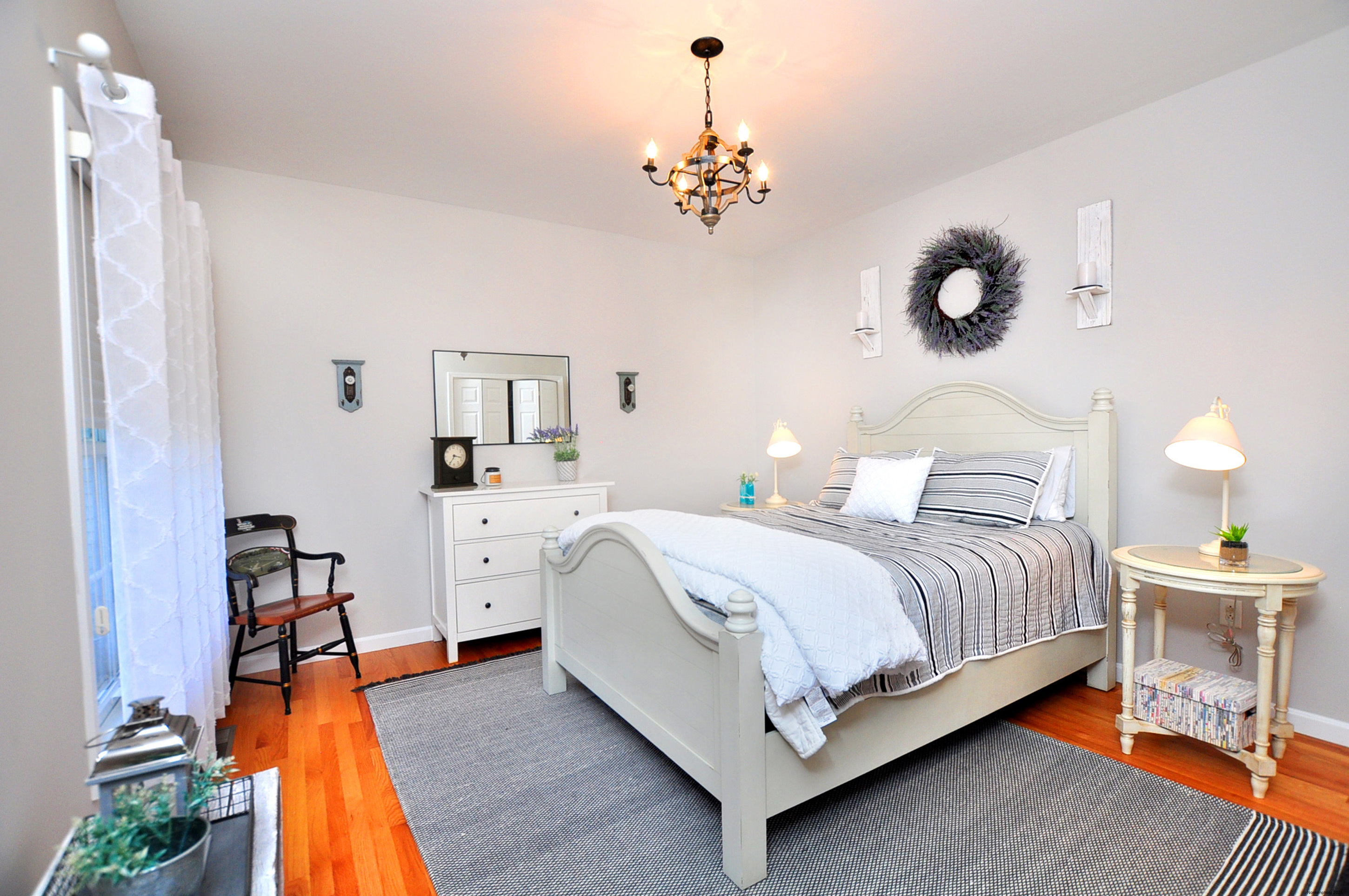 23 Dewberry Court, Unit 23 Suffield, CT 06078 - Photo 30 of 40 a spacious bedroom with a bed and a chandelier