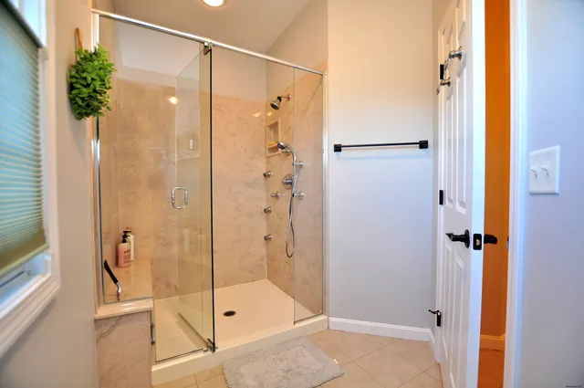 a bathroom with a shower and a sink